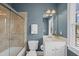 Full bathroom with glass shower, vanity with a sink, and natural light at 310 Millsfield Drive Dr, Cary, NC 27519