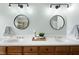 Bathroom featuring double sinks, framed circular mirrors, and ample counter space at 310 Millsfield Drive Dr, Cary, NC 27519