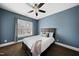 Comfortable bedroom with a large window offering natural light and a ceiling fan at 310 Millsfield Drive Dr, Cary, NC 27519