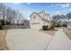 View of the side of the home and the driveway with parking for several cars at 310 Millsfield Drive Dr, Cary, NC 27519