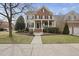 Charming brick two-story home with a welcoming front porch and landscaped yard at 310 Millsfield Drive Dr, Cary, NC 27519