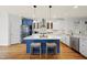 Gourmet kitchen with an island, pendant lighting, stainless appliances, and hardwood floors at 310 Millsfield Drive Dr, Cary, NC 27519