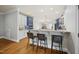 Bright kitchen features modern appliances, white cabinets, and a breakfast bar with seating at 310 Millsfield Drive Dr, Cary, NC 27519