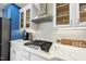Kitchen detail showcases stainless steel appliances, white cabinets, and sleek countertops at 310 Millsfield Drive Dr, Cary, NC 27519