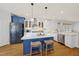Bright, modern kitchen with a center island, stainless steel appliances, and hardwood floors at 310 Millsfield Drive Dr, Cary, NC 27519