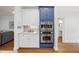 Elegant kitchen featuring white and blue cabinets, stainless steel appliances, and hardwood floors at 310 Millsfield Drive Dr, Cary, NC 27519