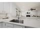 Kitchen sink featuring white countertops and a view into the light-filled living area at 310 Millsfield Drive Dr, Cary, NC 27519