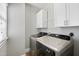 Bright laundry room with front load washer and dryer and extra cabinet space at 310 Millsfield Drive Dr, Cary, NC 27519