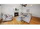 Cozy living room boasts a fireplace, ceiling fan, and comfortable seating area at 310 Millsfield Drive Dr, Cary, NC 27519