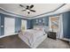 Spacious main bedroom with en-suite bathroom, tray ceiling, and a ceiling fan at 310 Millsfield Drive Dr, Cary, NC 27519