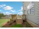 Wooden back deck offers a peaceful view of the spacious backyard and surrounding landscape at 311 Hanging Elm Ln, Fuquay Varina, NC 27526