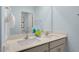Bright bathroom with double vanity, white countertops, and calming blue walls at 311 Hanging Elm Ln, Fuquay Varina, NC 27526
