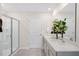 Modern bathroom featuring a glass-enclosed shower, double vanity sinks, and bright lighting at 311 Hanging Elm Ln, Fuquay Varina, NC 27526