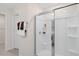 Clean bathroom with shower featuring a glass door and built-in shelving at 311 Hanging Elm Ln, Fuquay Varina, NC 27526