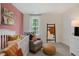 Serene Bedroom featuring a cozy chair, crib, and a playful accent wall at 311 Hanging Elm Ln, Fuquay Varina, NC 27526