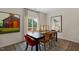 Dining room features a modern table, stylish chairs, and natural light from the sliding glass door to the deck at 311 Hanging Elm Ln, Fuquay Varina, NC 27526