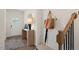 Inviting entryway with wood floors, console table, round mirror, coat rack and bench seating at 311 Hanging Elm Ln, Fuquay Varina, NC 27526