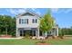 Beautiful two-story home with stone accents, shutters, and a well-maintained front yard at 311 Hanging Elm Ln, Fuquay Varina, NC 27526