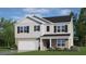 Charming two-story home featuring a brick and siding exterior, well-manicured lawn and a two car garage at 311 Hanging Elm Ln, Fuquay Varina, NC 27526
