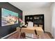 Elegant home office with dark accent wall, modern desk, bookcase, and soft natural lighting at 311 Hanging Elm Ln, Fuquay Varina, NC 27526
