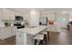 Modern kitchen featuring granite countertops, stainless steel appliances and a large island with seating at 311 Hanging Elm Ln, Fuquay Varina, NC 27526