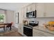 Beautifully appointed kitchen features modern appliances, white tile backsplash and granite counters at 311 Hanging Elm Ln, Fuquay Varina, NC 27526