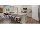 Bright open kitchen with granite countertops, stainless appliances and a large island with barstool seating at 311 Hanging Elm Ln, Fuquay Varina, NC 27526