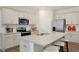 Modern kitchen features stainless steel appliances, granite countertops, and a spacious center island with seating at 311 Hanging Elm Ln, Fuquay Varina, NC 27526