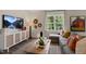 Living room boasts stylish decor, a comfortable sectional sofa, and a large window view, creating an inviting atmosphere at 311 Hanging Elm Ln, Fuquay Varina, NC 27526