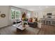 Inviting living room with comfortable seating, stylish decor, and an open view to the modern kitchen at 311 Hanging Elm Ln, Fuquay Varina, NC 27526