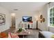 Bright living room with modern decor, stylish furniture, and an adjacent bathroom that is partially visible at 311 Hanging Elm Ln, Fuquay Varina, NC 27526