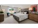 Bright main bedroom with a stylish bed frame, cozy seating, and natural light at 311 Hanging Elm Ln, Fuquay Varina, NC 27526