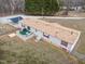 Back view of home featuring large back deck, storage shed, and convenient covered parking at 341 Acorn Ct, Rougemont, NC 27572
