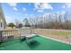 Enjoy outdoor living on this quaint deck, complete with green carpet and comfortable seating at 341 Acorn Ct, Rougemont, NC 27572