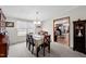 Dining room with view to kitchen, table for six, and a window overlooking the outside at 341 Acorn Ct, Rougemont, NC 27572