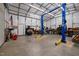 Large garage interior with two post lift and wood stove at 341 Acorn Ct, Rougemont, NC 27572
