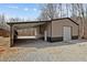 Exterior view of garage with covered parking area and gravel driveway at 341 Acorn Ct, Rougemont, NC 27572