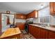 Another view of the kitchen with wooden cabinets, sink, and range at 341 Acorn Ct, Rougemont, NC 27572