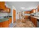 Functional kitchen featuring wooden cabinets, tile flooring, and essential appliances at 341 Acorn Ct, Rougemont, NC 27572