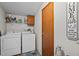 Laundry room with full-size washer and dryer and extra storage at 341 Acorn Ct, Rougemont, NC 27572