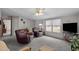 Inviting living room with dual recliner chairs, large windows, and entertainment setup at 341 Acorn Ct, Rougemont, NC 27572