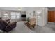 Relaxing living room setting with comfortable seating, a ceiling fan, and soft carpet flooring at 341 Acorn Ct, Rougemont, NC 27572
