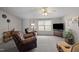 Comfortable living area with plush recliner seating, large windows, and television at 341 Acorn Ct, Rougemont, NC 27572