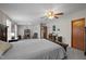 Bright main bedroom featuring a large bed, desk, and view to other rooms at 341 Acorn Ct, Rougemont, NC 27572