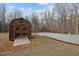 Exterior view of wooden shed on a gravel lot surrounded by trees at 341 Acorn Ct, Rougemont, NC 27572