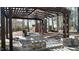 A close view of a backyard patio with a stone fire pit and a wooden pergola at 3510 Middlebrook Dr, Durham, NC 27705