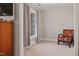 Cozy bedroom with neutral walls, plush carpet, and a patterned accent chair by the window at 3510 Middlebrook Dr, Durham, NC 27705