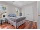 Bedroom with hardwood floors, neutral paint and large windows at 3510 Middlebrook Dr, Durham, NC 27705