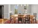 Dining room with a large wooden table, area rug, and abundant natural light at 3510 Middlebrook Dr, Durham, NC 27705