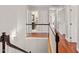 Hallway with wood flooring and a banister, leading to various rooms at 3510 Middlebrook Dr, Durham, NC 27705